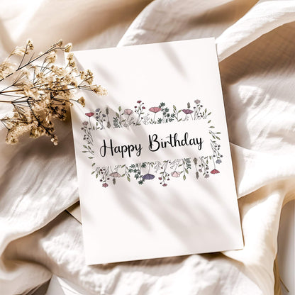 Minimalist floral birthday card with delicate pink wildflowers and modern calligraphy on white linen background with dried baby's breath. Digital printable birthday greeting card in botanical style